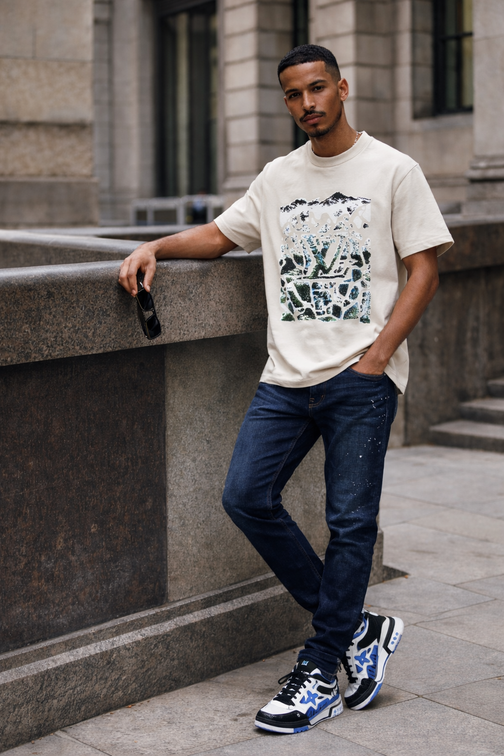 Cream graphic tee with blue sneakers